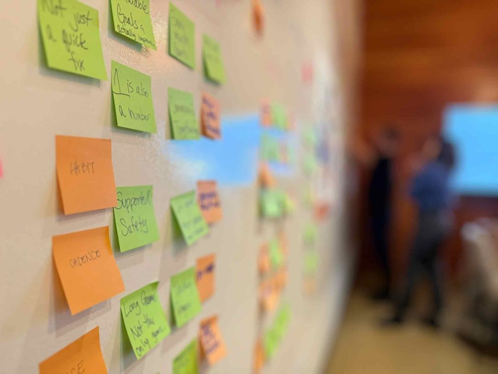Customer experience workshop sticky notes reading “Not just a quick fix”, “1 is also a number”, “Supported Safety”, “Habit”, “Cadence” and “Long game, not the only game”